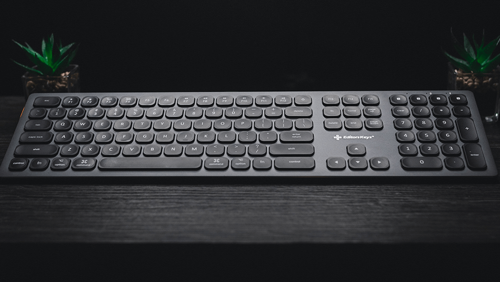 wireless keyboard on black desk